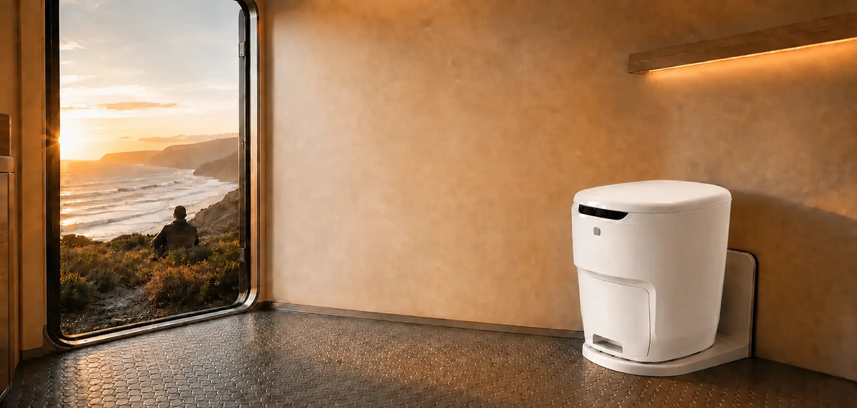 Waterless RV toilet inside a motorhome overlooking the coast at sunset